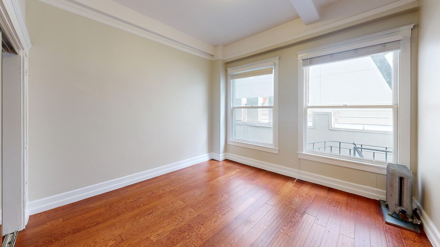 A room with wooden floors and white walls.